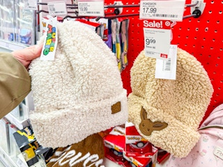hand holding a super mario beanie in front of target signage