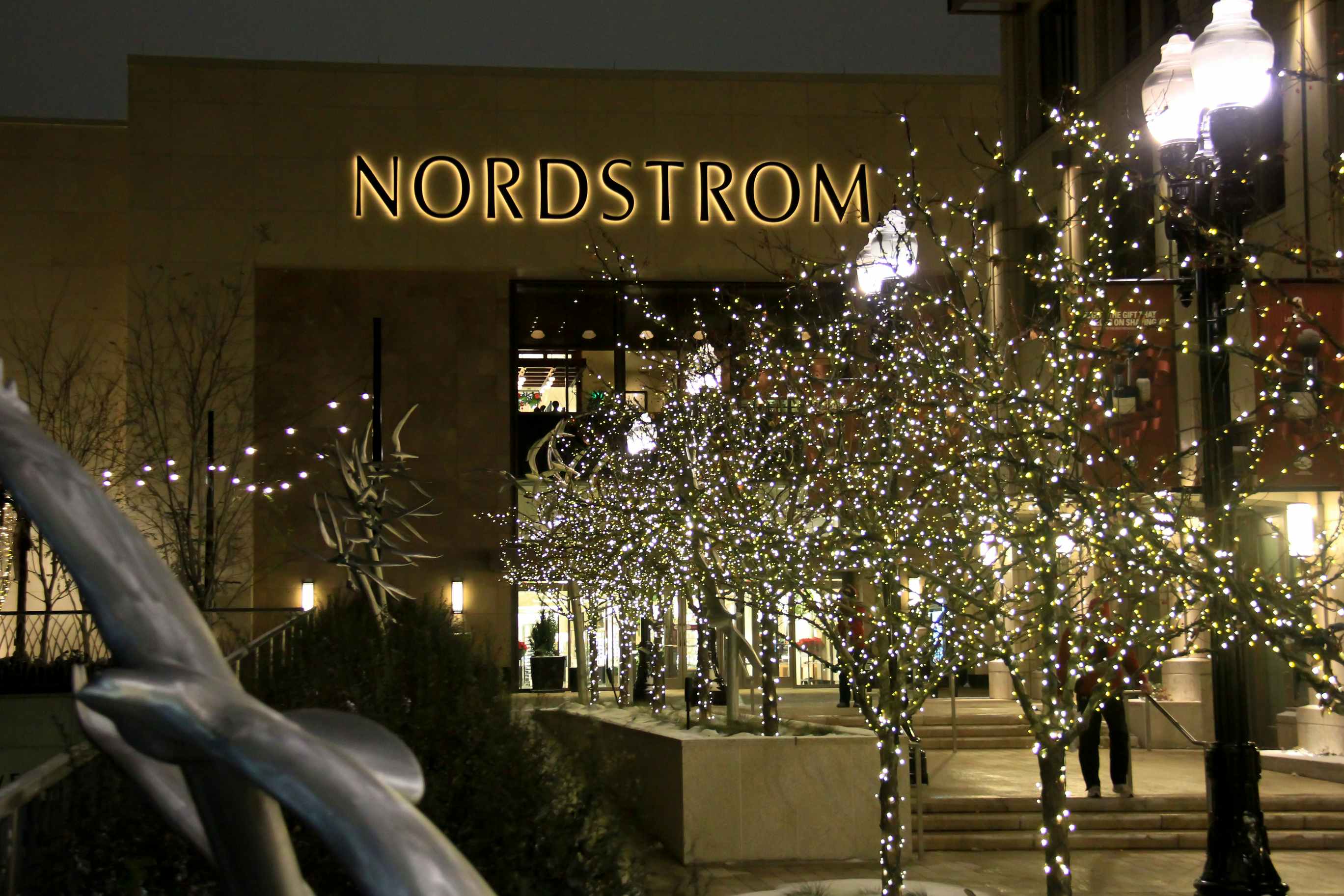 Trees decorated for Christmas outside of a Nordstrom department store