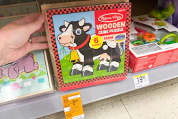 hand touching melissa and doug puzzle on clearance