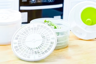 Lifestyle image of a salad spinner in kitchen setting
