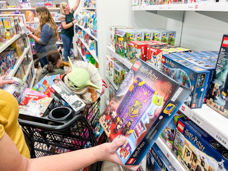 Person holding a Harry Potter lego kit in a toy section at Kohl's