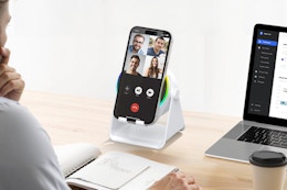 Man using the GIM Wireless Induction Speaker, 4 in 1 Bluetooth Speaker Phone Stand while working.