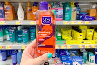 bottle of clean and clear held in front of walmart skin care aisle