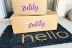 two zulily boxes stacked on a front porch