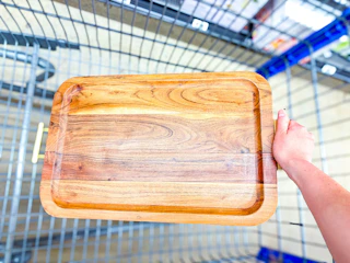 hand holding better homes & gardens acacia wood tray over walmart cart