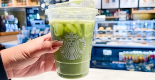 a starbucks drink being grabbed in starbucks