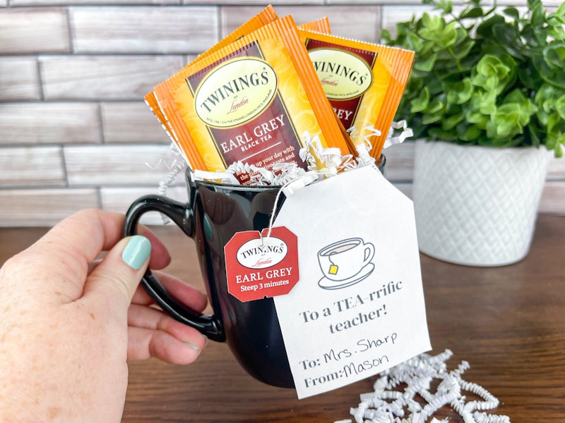 a person holding a tea time teacher gift 