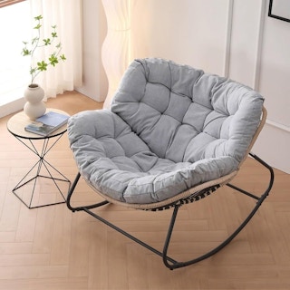 A wire-frame indoor-outdoor rocking chair with a 2-part papasan seat covered by a light grey cushion