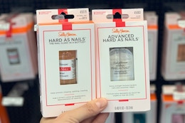 hand holding sally hansen nail strengthener