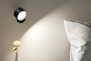 a walls sconce near a bed