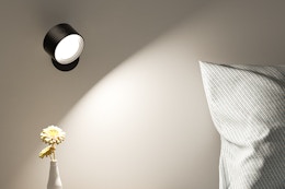 a walls sconce near a bed