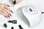 a woman near a nail lamp