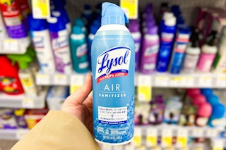 person holding a bottle of lysol air sanitizer