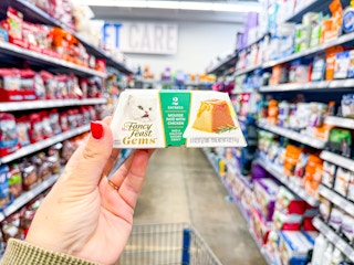 Fancy Feast Cat Food held up in center of pet aisle at Walmart