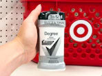 hand holding a twin pack of degree deodorant in front a target basket