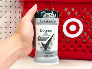 hand holding a twin pack of degree deodorant in front a target basket