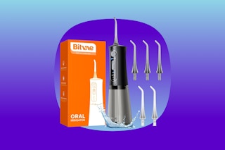 A Bitvae black and grey water flosser with five extra heads and an orange box