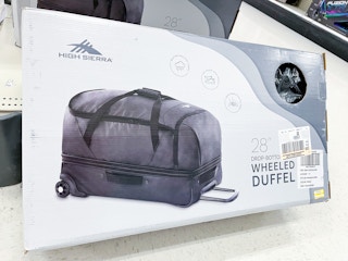 a high sierra wheeled duffle bag on clearance sitting on a target shelf