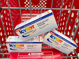 Three boxes of Icy Hot Original Pain Relief Cream sitting in a cart at Target