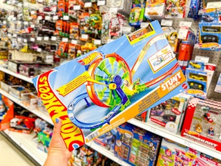 hand holding a hot wheels track set at target