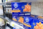kraft deluxe mac and cheese stacked on store shelf