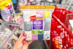 hand holding a pack of hanes kids' underwear in front of a target cart