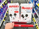 two Huggies Snug and Dry diaper packs inside shopping cart