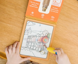 a kid coloring a picture with a water pen