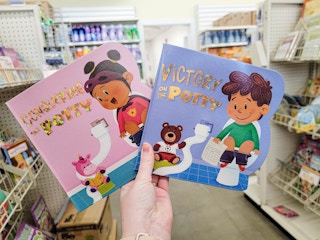 hand holding potty training kids books