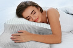 a woman using a cervical pillow