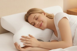 woman laying in bed on a cervical pillow