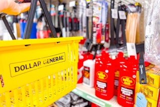 hand holding dollar general basket in front of grilling section