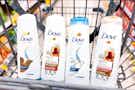 four bottles of dove hair care in walgreens shopping cart in store aisle