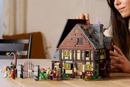 a person building a Lego Hocus Pocus house