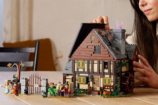 a person building a Lego Hocus Pocus house