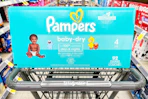 box of Pampers baby-dry diapers in Walgreens shopping cart