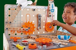 child playing with the pretend play workbench