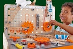child playing with the pretend play workbench