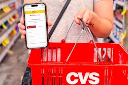 someone holding up the kcl app connecting their CVS account