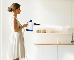 a person using a steam cleaner 