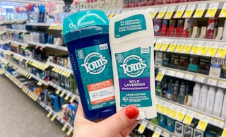 hand holding sticks of tom's of maine deodorant