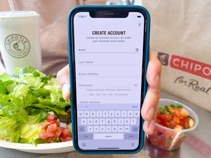 someone holding phone with chipotle app