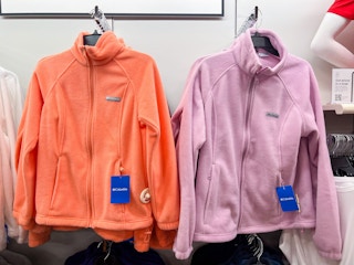 two columbia full-zip jackets hanging on a rack