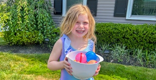 reusable water balloons can save you money child holding bowl of balloons kcl feature 1686076923 1686076923