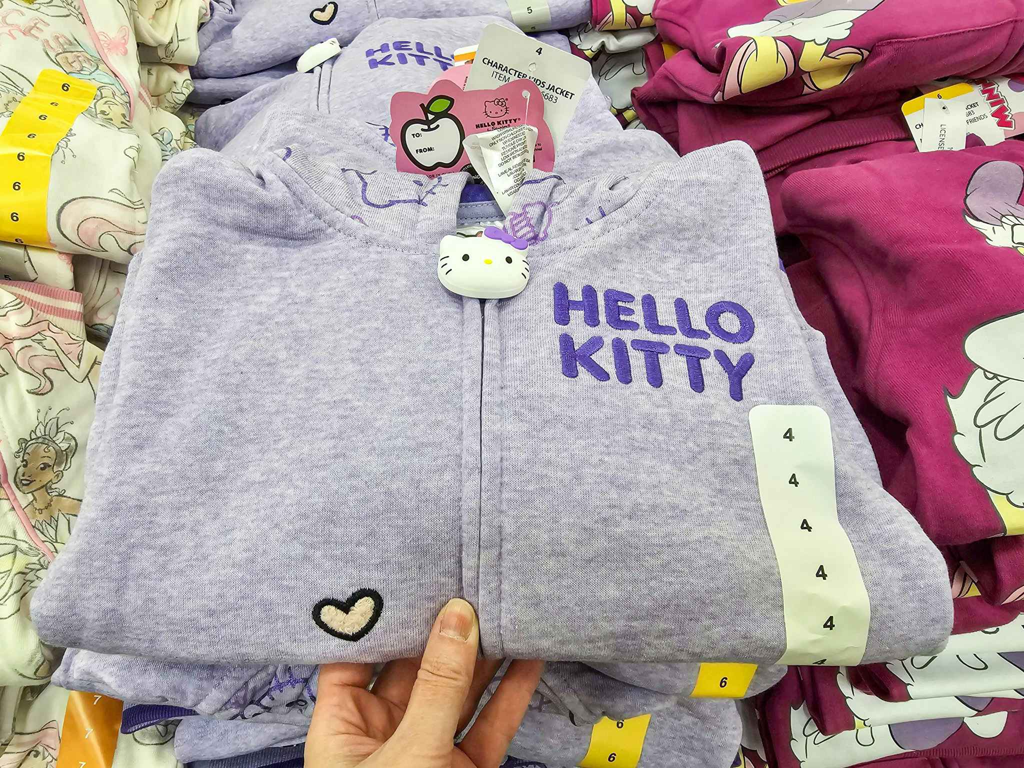 person grabbing a hello kitty kids hoodie