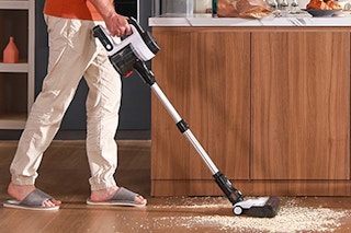a man vacuuming a spill
