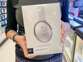 woman holding bose noise cancelling headphones at target