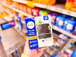Febreze Scent Booster held up in store at Walmart (with blurred background)
