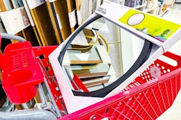 room essentials round wall mirror sitting in a target cart