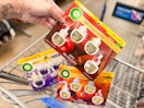 hand holding a four pack of air wick refills over walmart cart